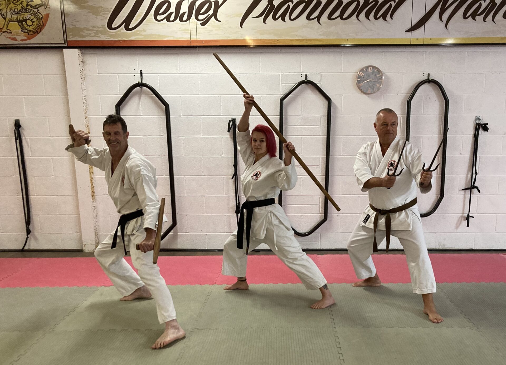 Kobudo students demonstrating tonfa, bo and sai
